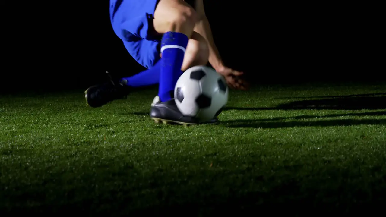 Soccer player performing a sliding tackle on playing field 4k