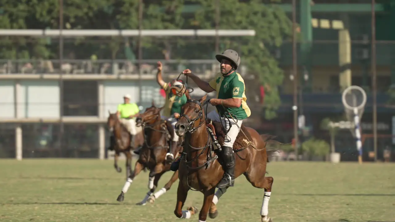 Pato player scores goal into netted hoop with ball Argentine horseback sport