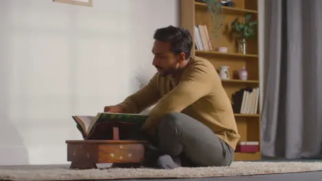 Muslim Man At Home Sitting And Reciting From The Quran