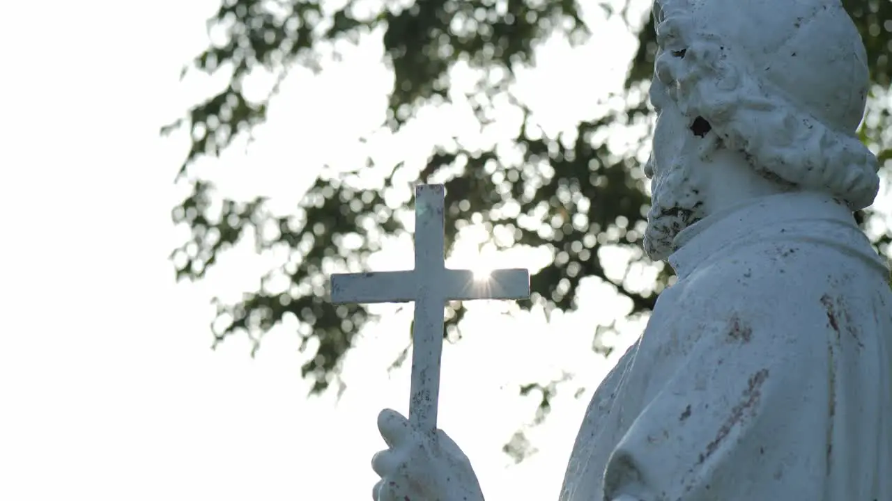 A statue of Saint Francis Zavier preaching in golden sunlight from the side