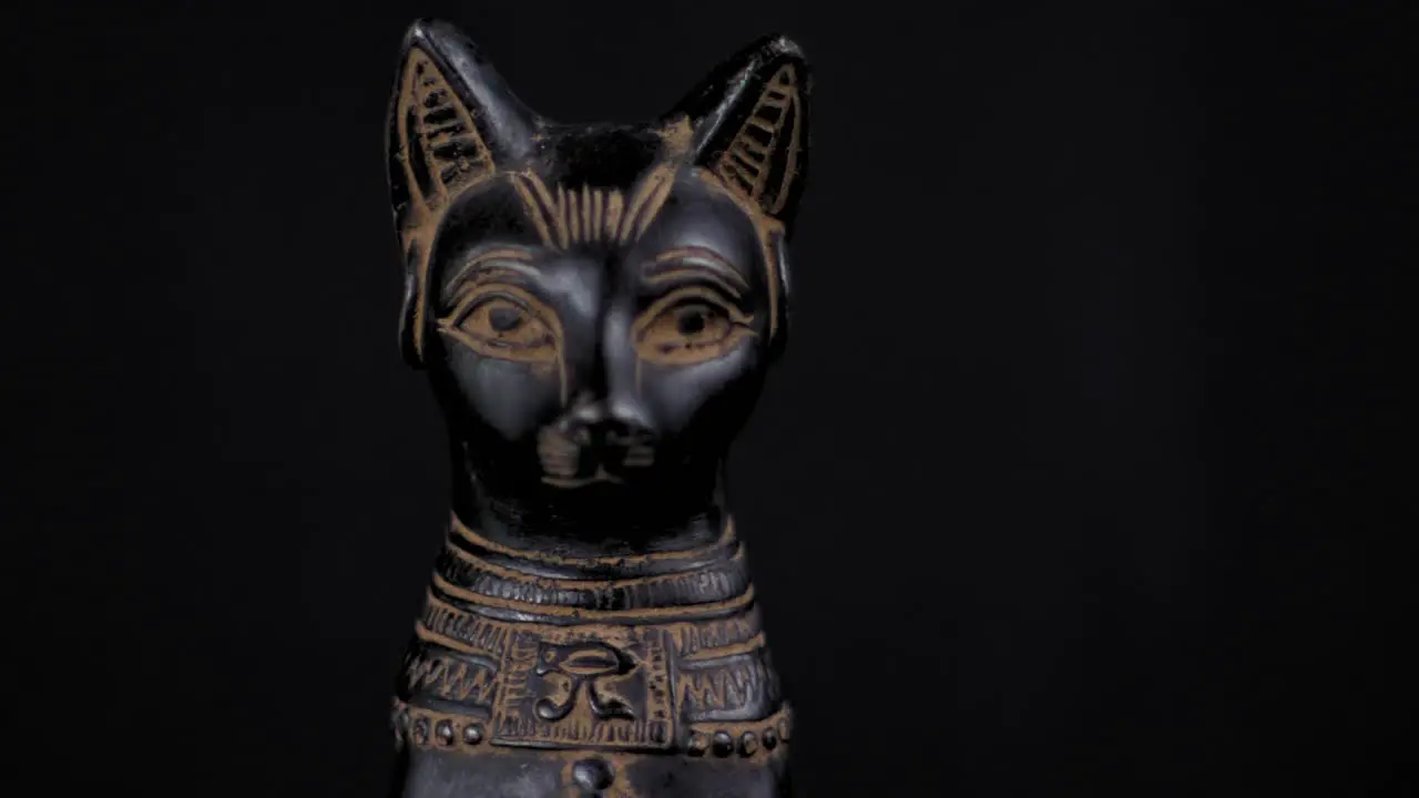 Dolly of a small replica Egyptian Statue of Bastet Facing Forward Close Up Right to Left