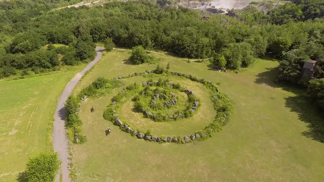 Flight towards a mysterious stone circle on a field