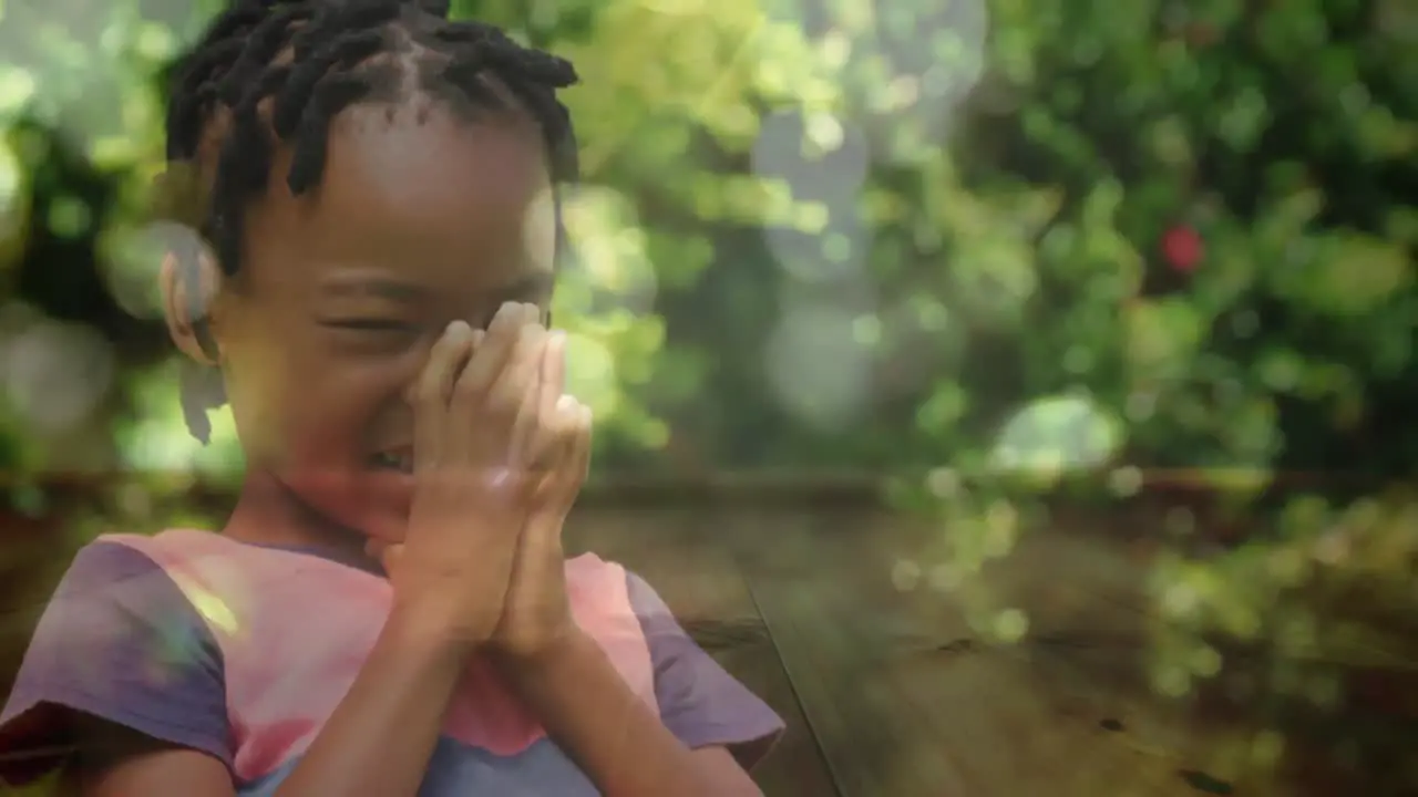 Little girl praying in the woods