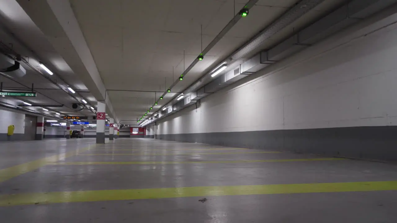 Smart parking zone with green blinking lights indicating free available parking space for vehicles