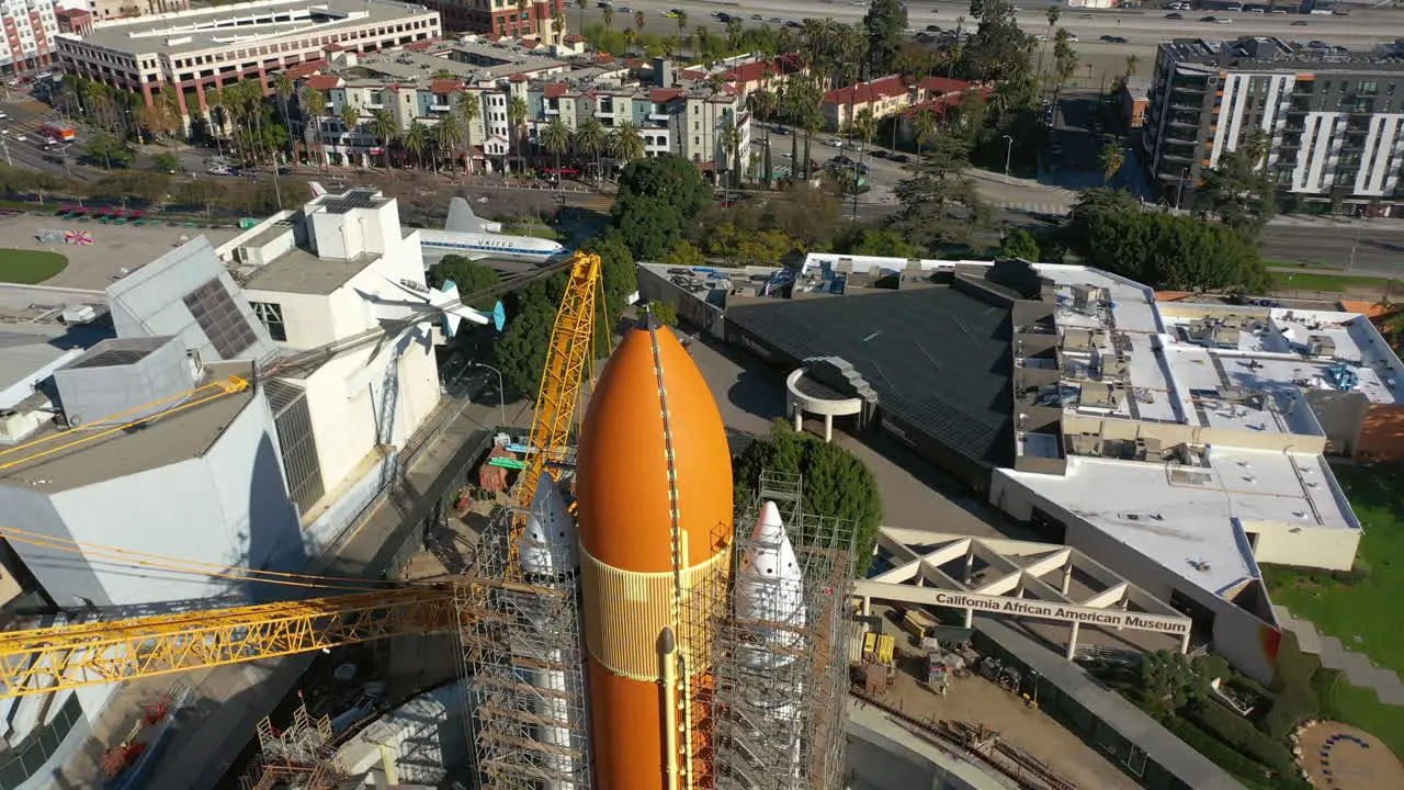 Drone flying backwards over a space rocket at a the California ScienCenter in LA