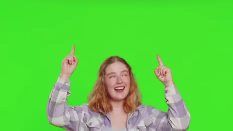 Young woman showing thumbs up and pointing on blank space place over head for advertisement logo