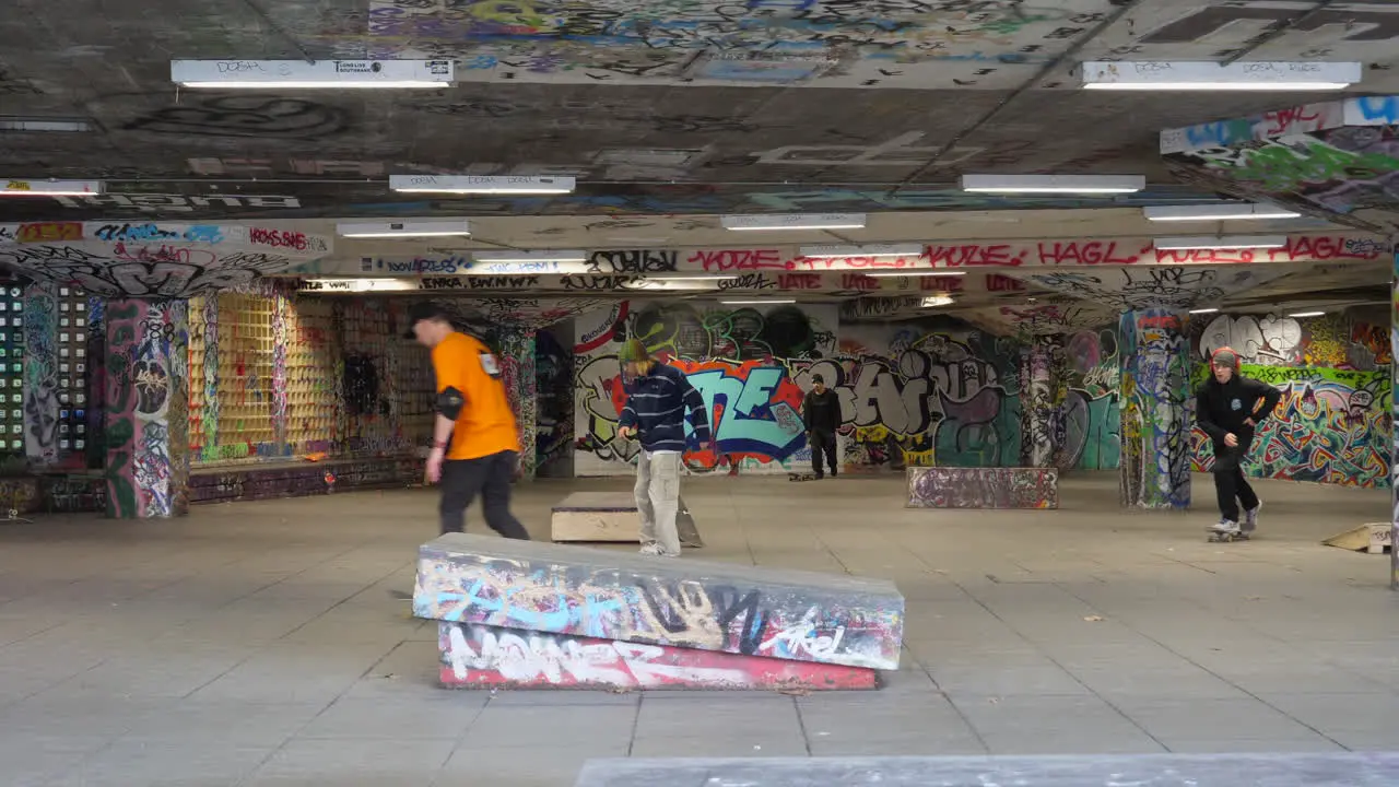 Skateboarders At The Southbank Skate Space With Graffiti Arts In London UK