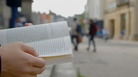 Close Up Shot of Someone Reading a Book On Clarendon Building Steps In Oxford