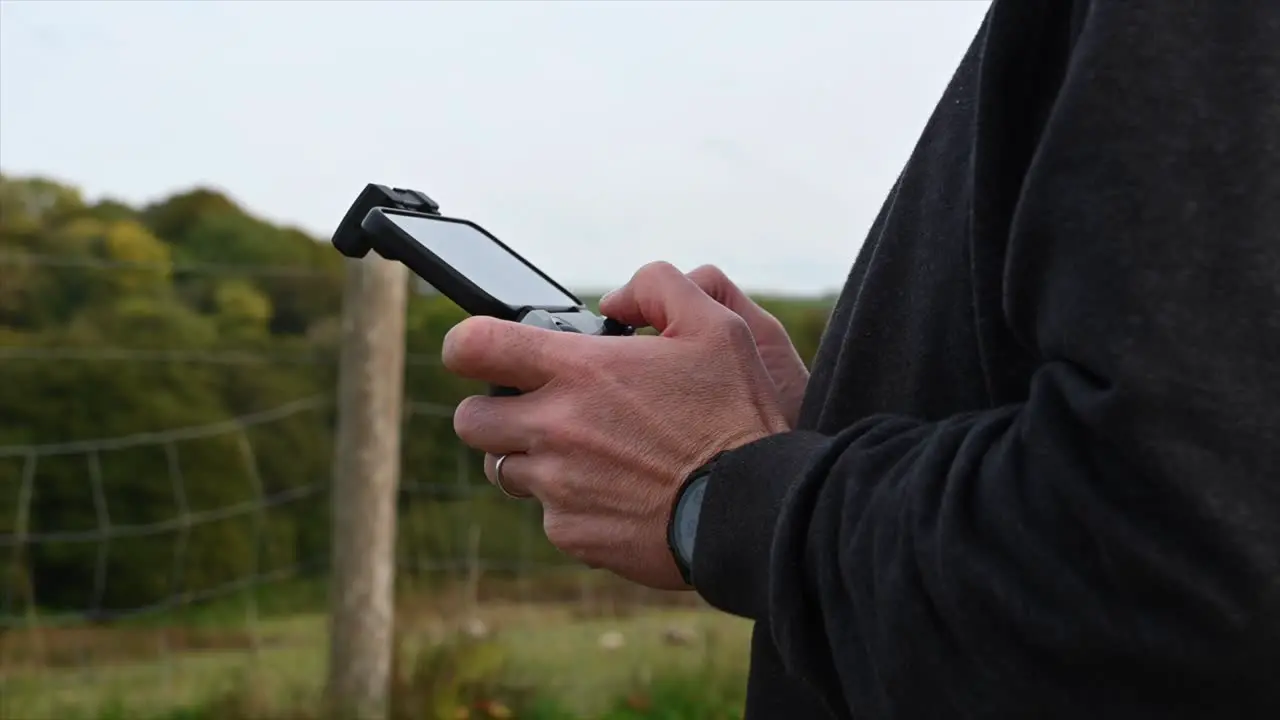 Cinematic shot of person using drone controller