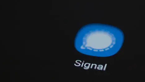 Close Up Shot of a Finger Tapping the Signal App On Smartphone Screen