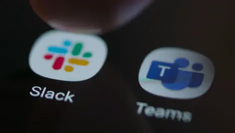 Close Up Shot of Finger Tapping the Slack App On a Smartphone