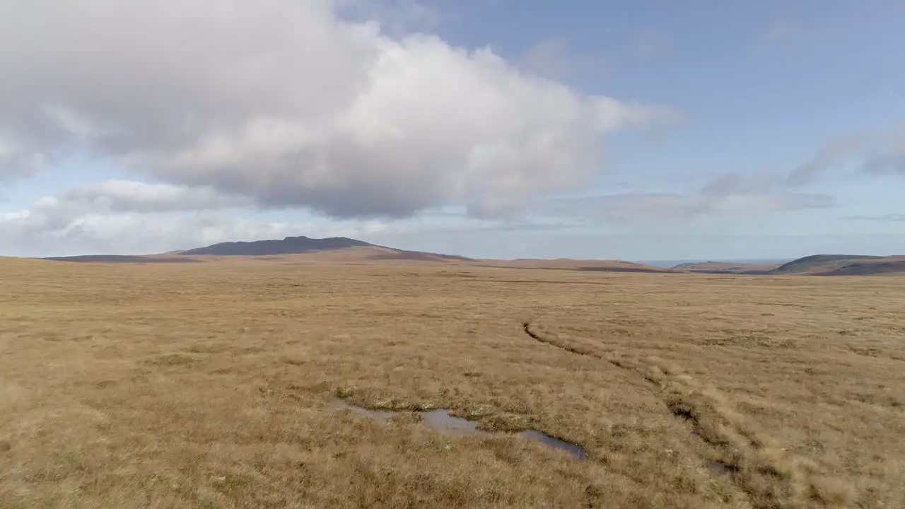 Aerial tracking low and fast above the moorland of the A Mhoine peninsula in Sutherland Scotland