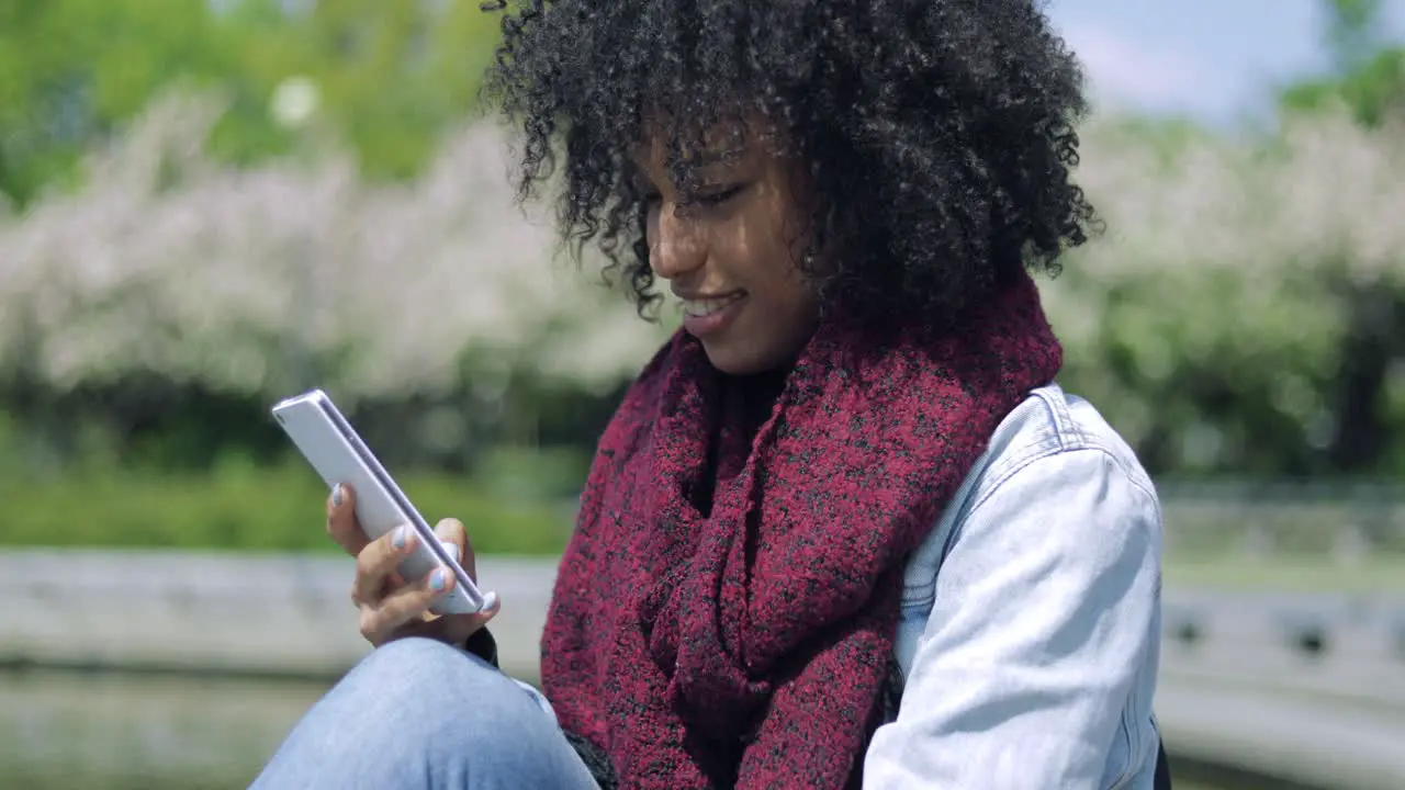 Cheerful girl using smartphone