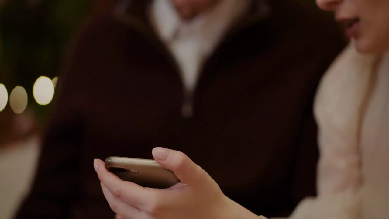 Woman Teaching Grandfather To Use Smartphone In Christmas 3