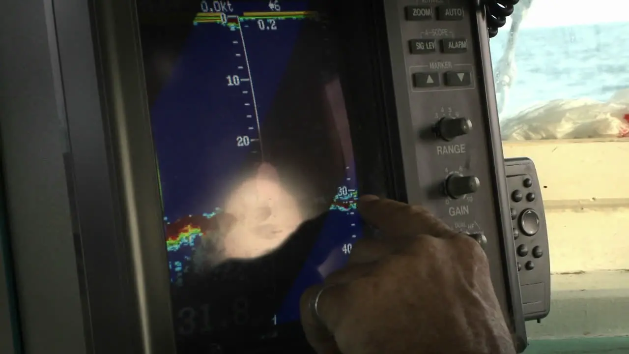 A man points with his finger on a monitor