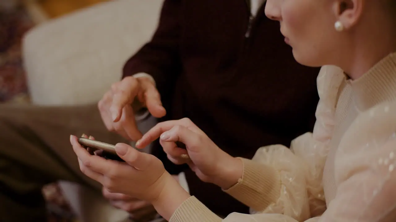 Female Teaching Grandfather To Use Cellphone In Christmas 2