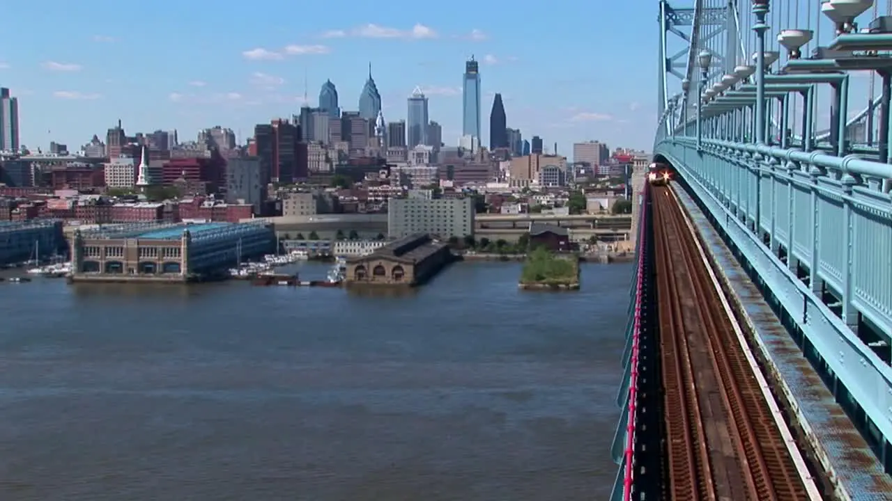 A rapid transit train drives across Ben Franklin Bridge away from Philadelphia Pennsylvania 1