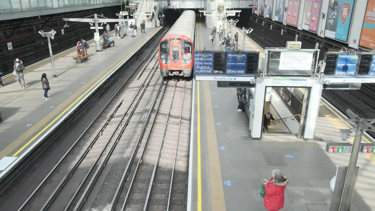 London District line underground train doors opening in Earls court shot from above