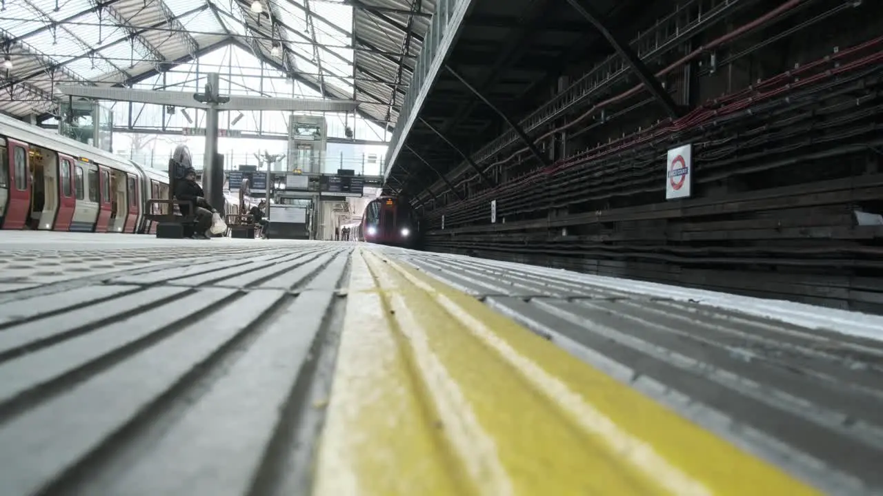 Platform low level shot London district line pulling into earls court train station London