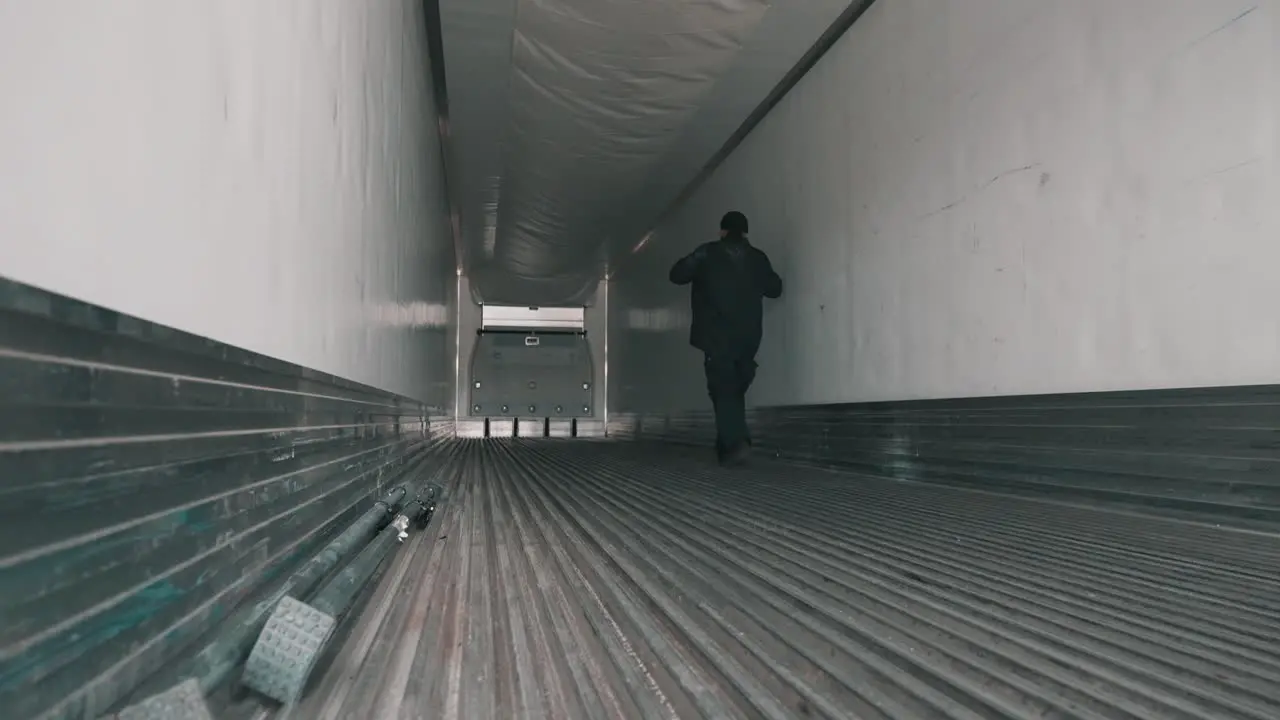 truck driver walking iside of a dry van trailer