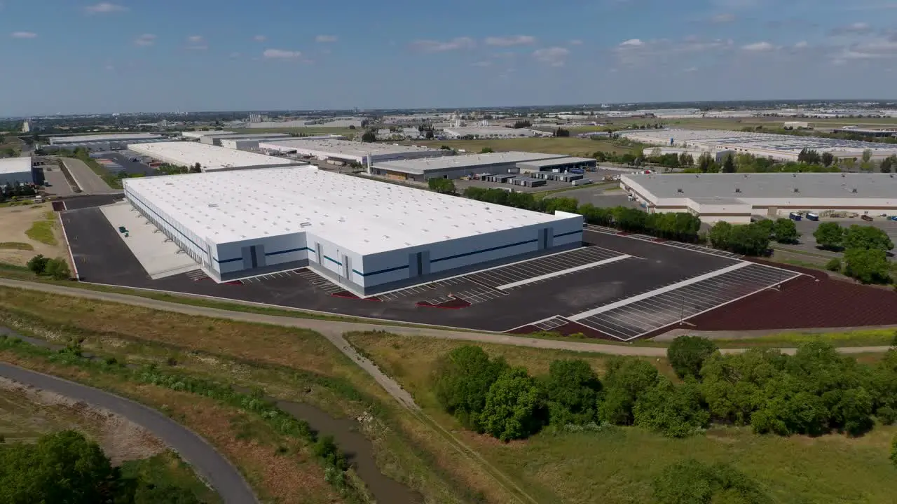 Aerial approach shot of new industrial building in an industrial area