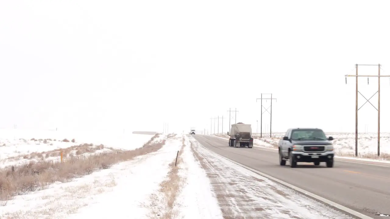 Traffic passes and a Walmart truck drives past on a cold winter highway