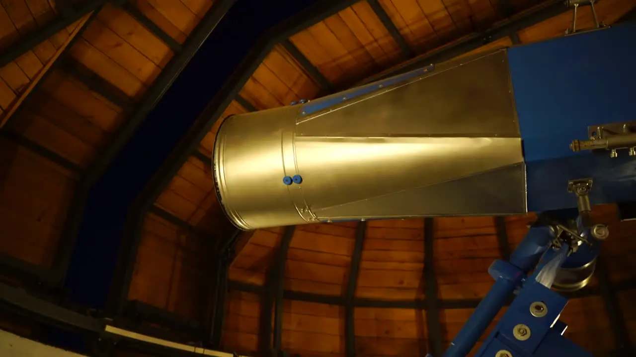 Ceiling opening on observatory to reveal night sky with telescope