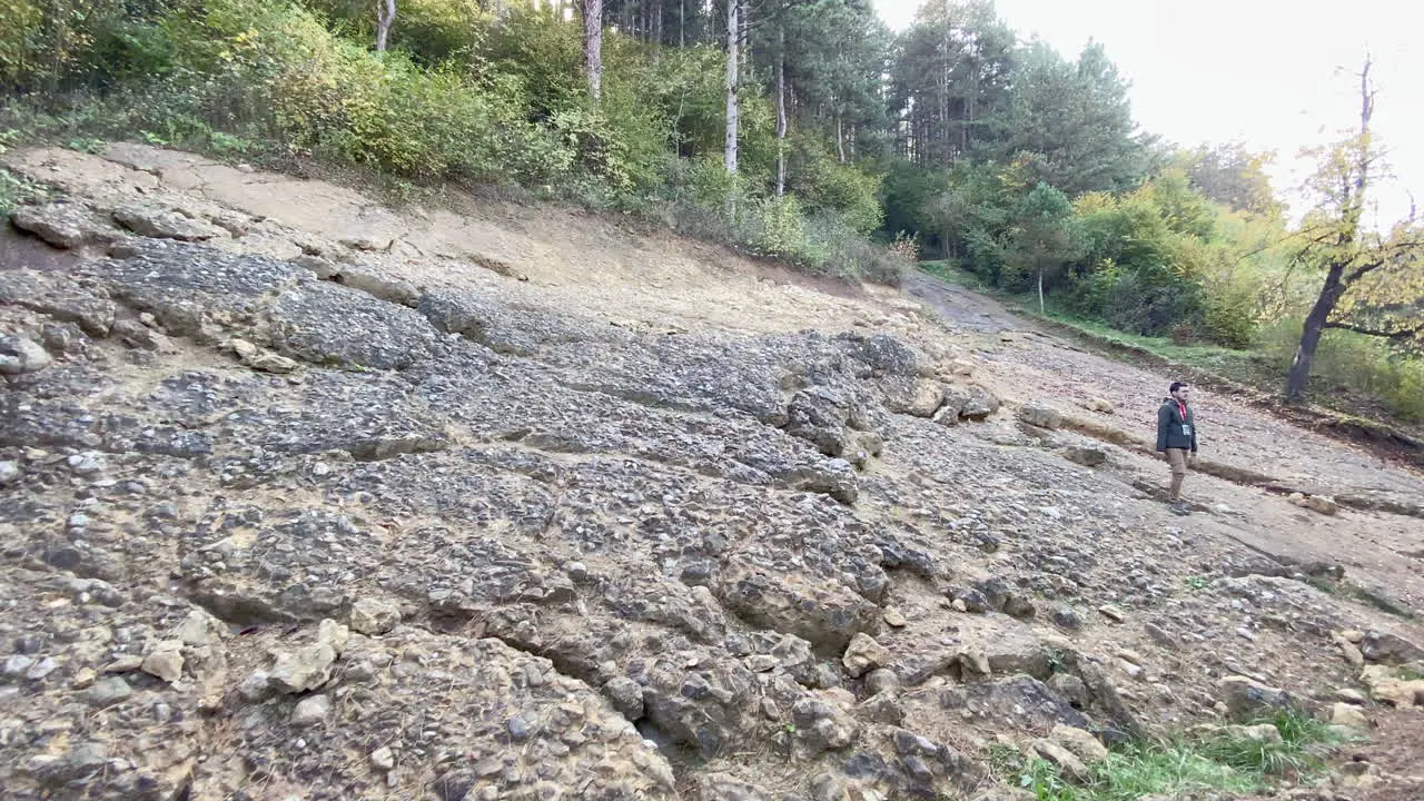 Wide shot shows tourist guide at excavations of sun pyramid in the Bosnian tale of the pyramids close to city Visoko Bosnia and Herzegovina