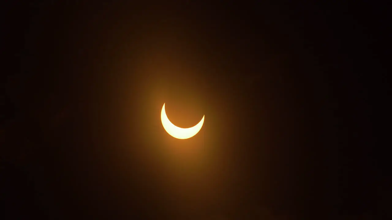 Clouds moving in front of a partial annular eclipse October 14th 2023