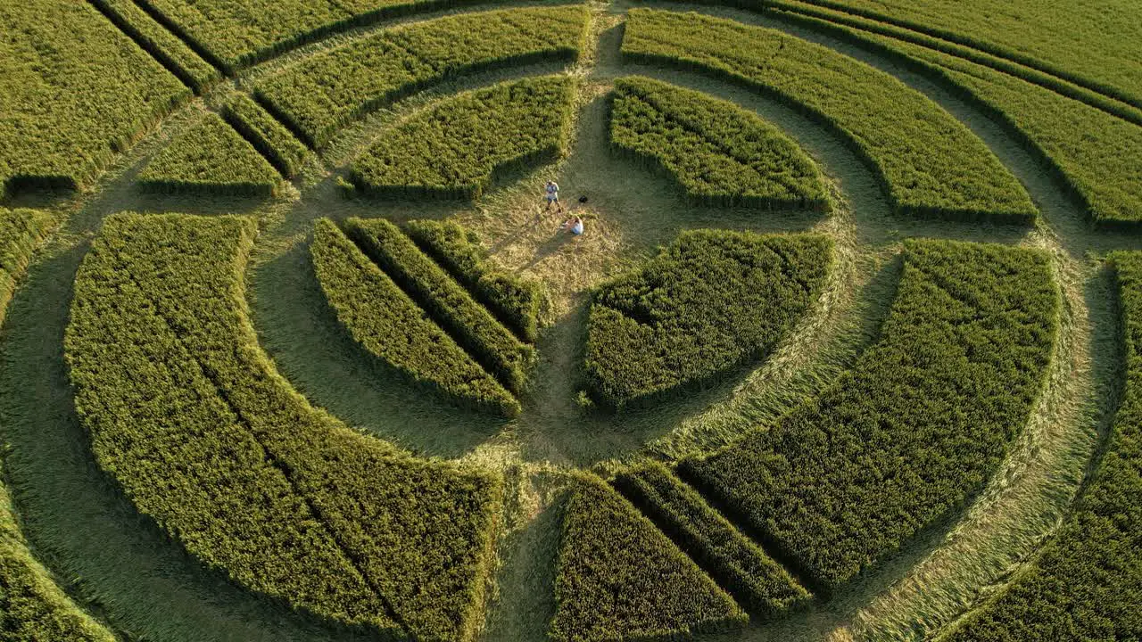 Hackpen hill strange crop circle pattern in rural grass farming meadow aerial view descending shot