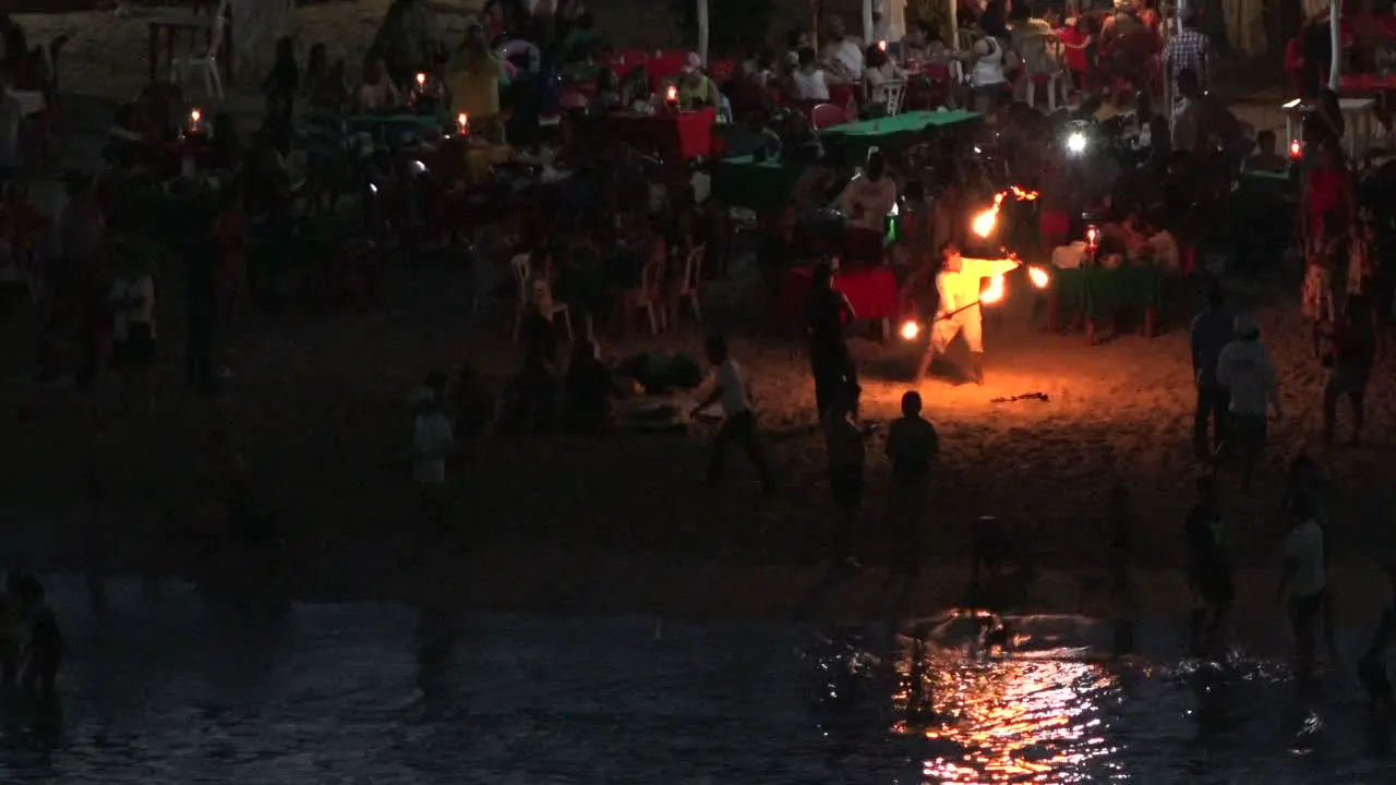 Mexico Huatulco man tosses fire pan