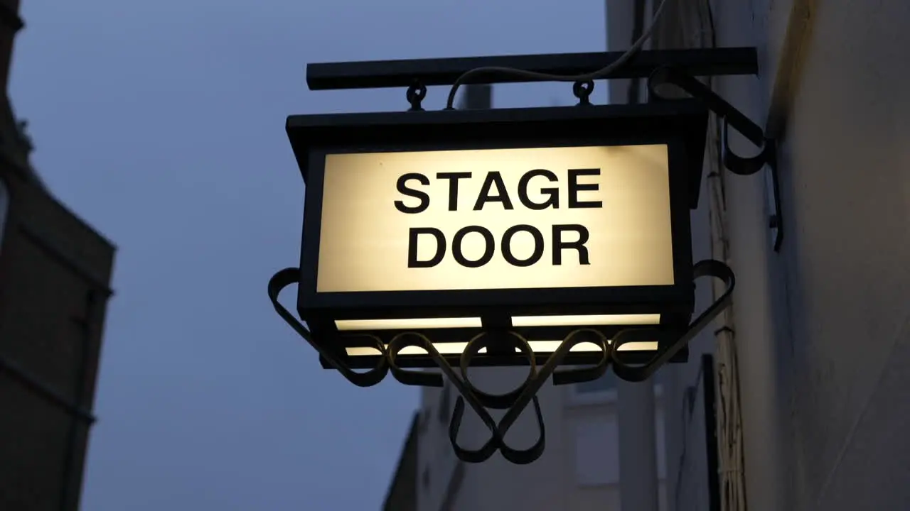 Illuminated stage door sign outside a theatre in London