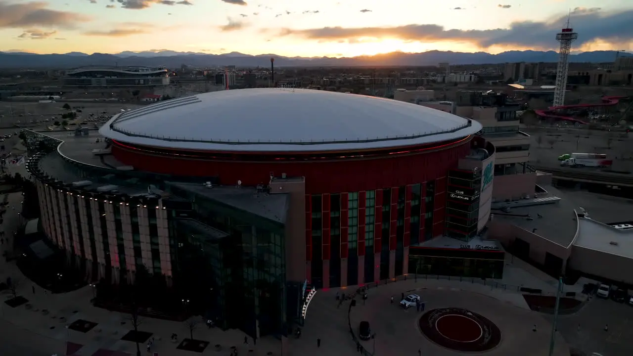 Half aerial orbit around Ball Arena in Denver vivid sunset sky