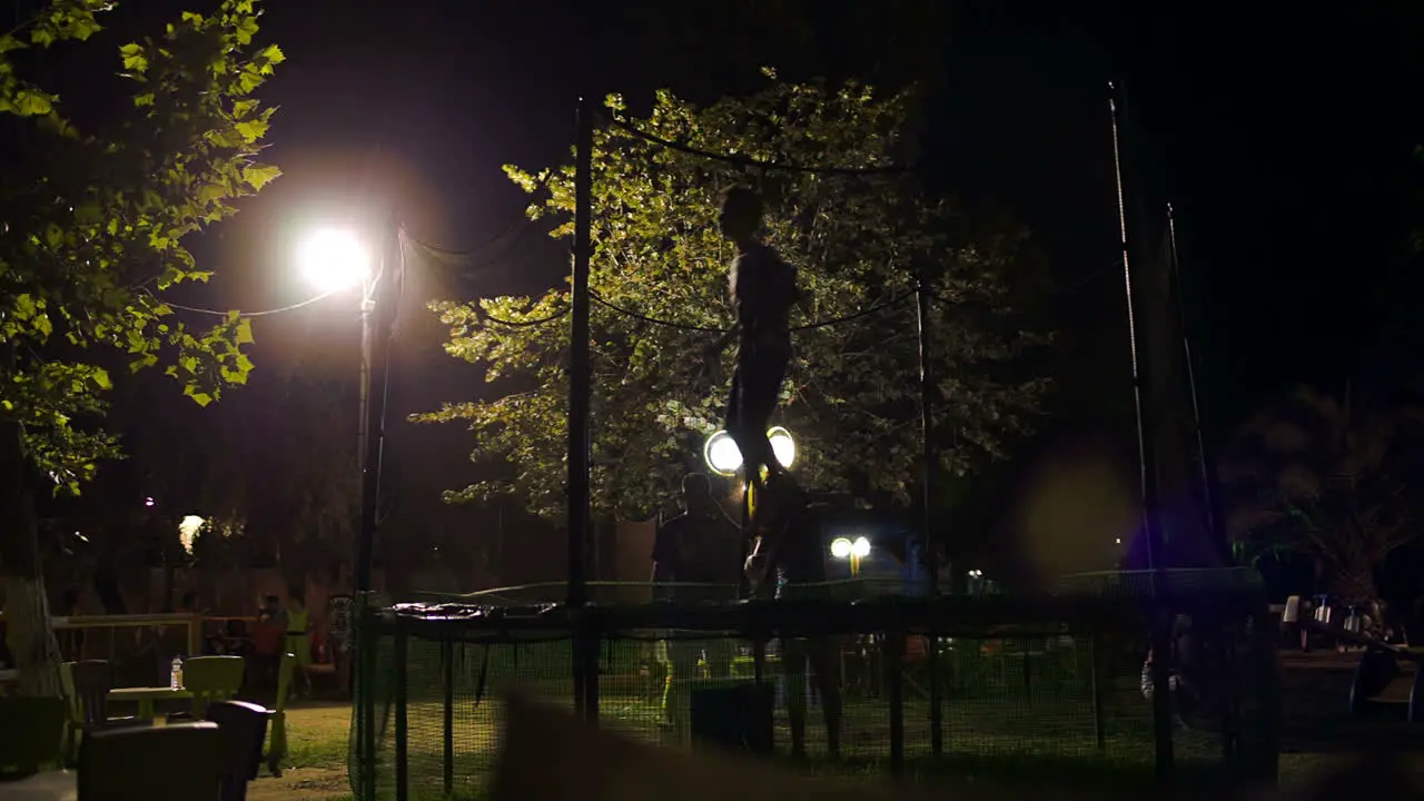 Boy jumping on trampoline amusement park