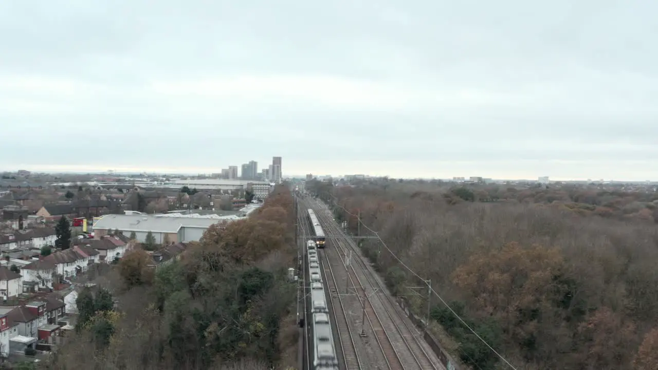 Dolly back drone shot of Great western railway high speed train and Heathrow express