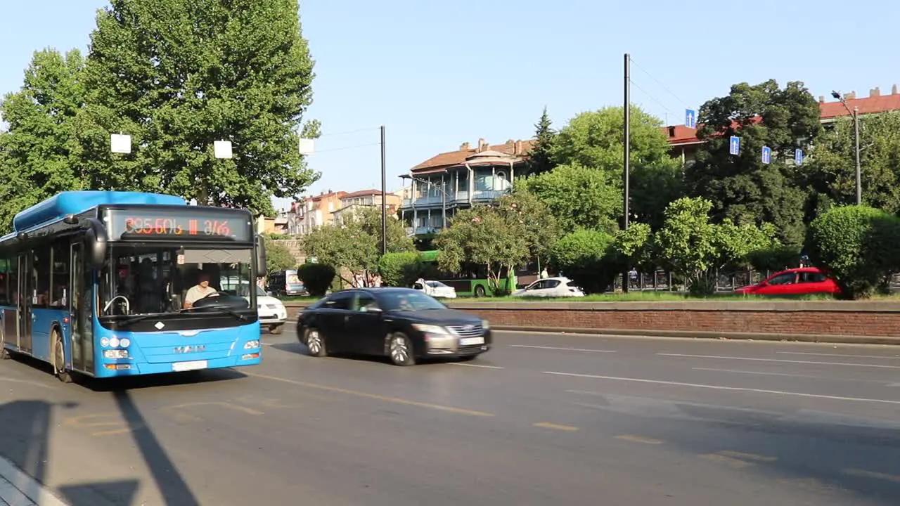 A Tbilisi City Tour Red Bus passing through the traffic