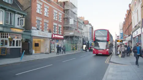 Shops On Putney High Street London Busy With Shoppers And Traffic