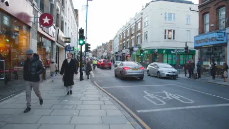 Shops On Putney High Street London Busy With Shoppers And Traffic 6