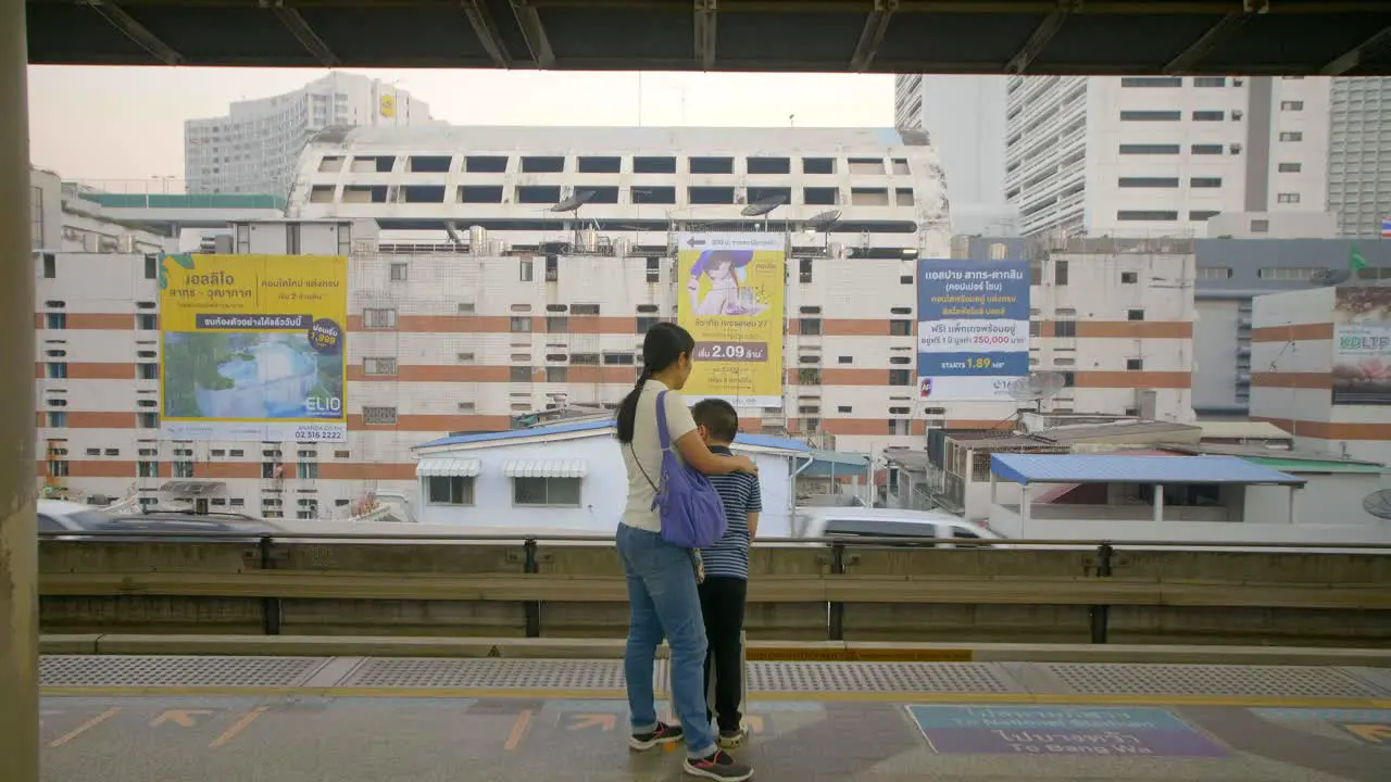 Mother and Son on Train Platform