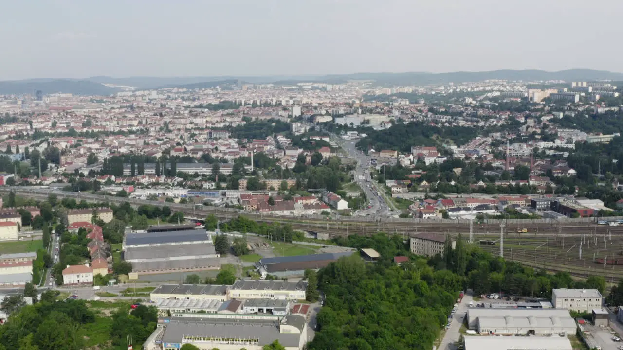 Timelapse of Brno city area with train passing on railroad tracks