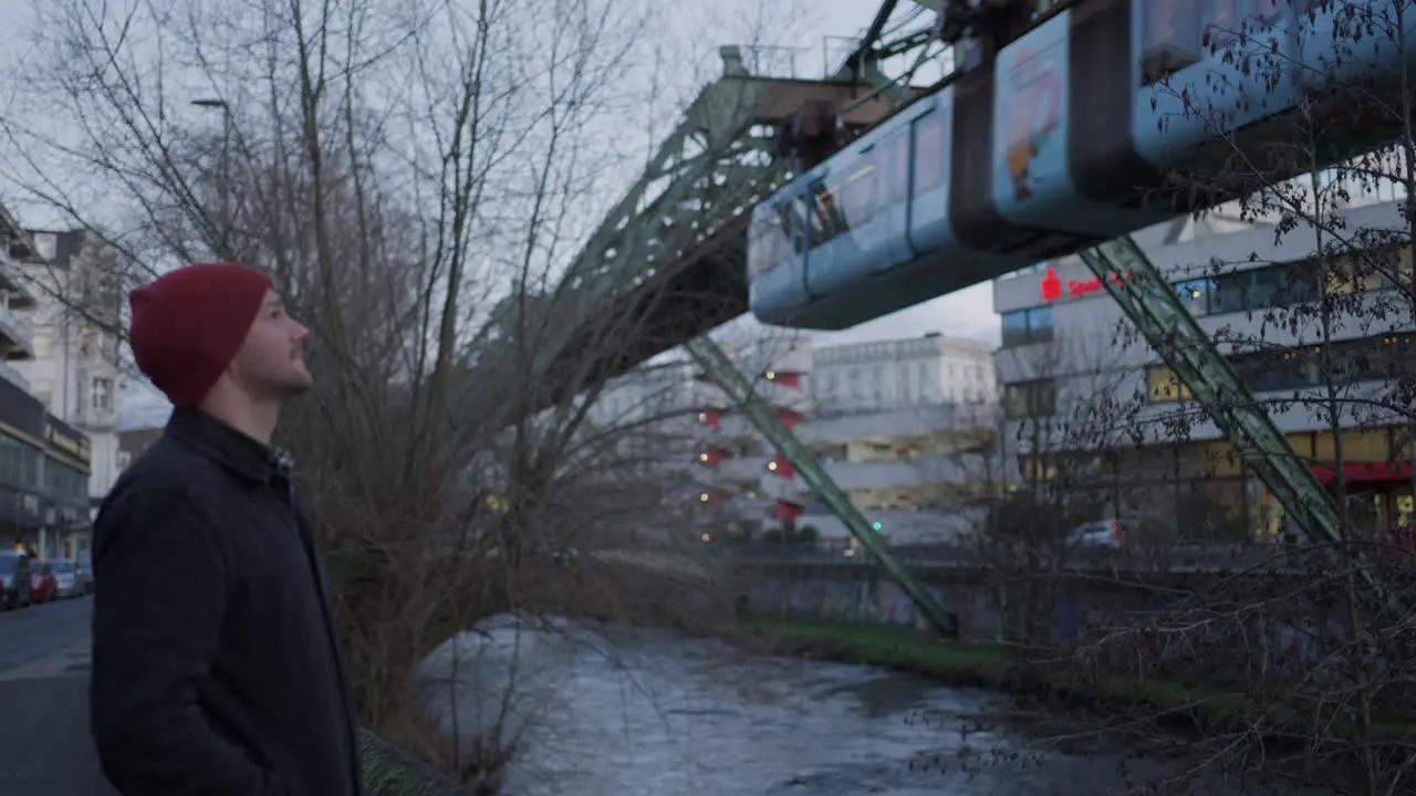 A Traveler in wonder watching Wuppertal's suspended railway system Germany