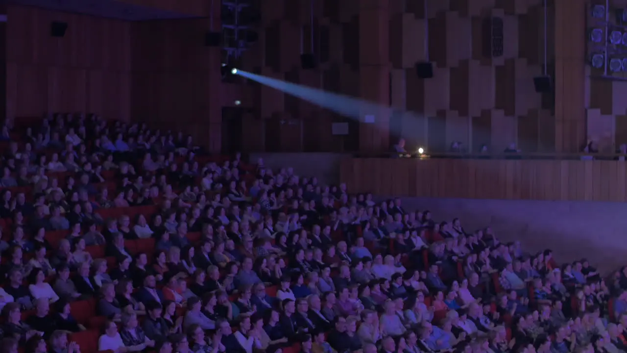 Applauding audience in movie theatre