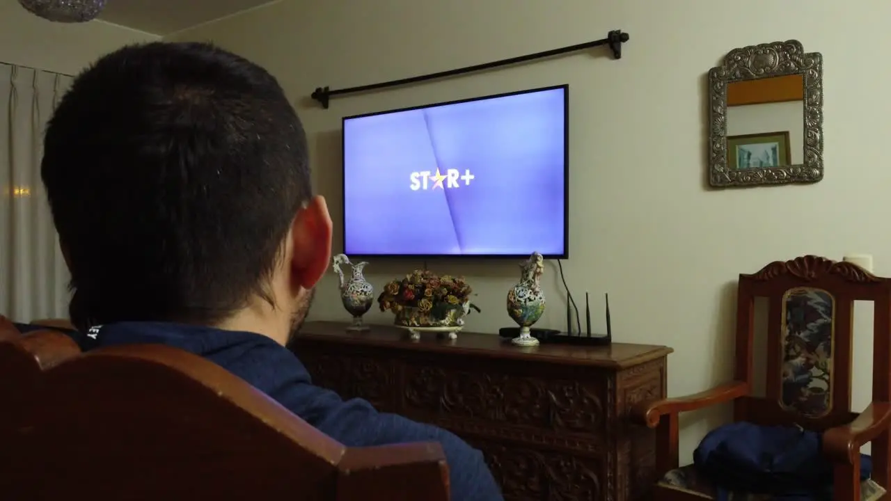 A person watching Star+ in the living room