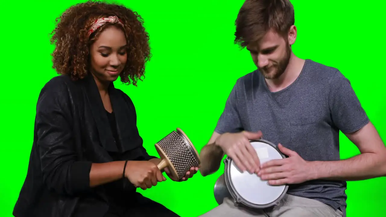 Happy musicians playing cabasa and drum