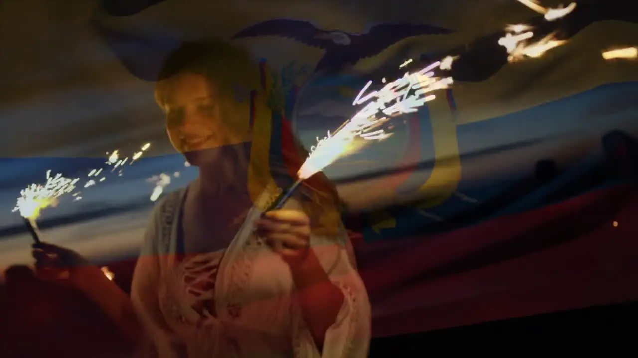 Animation of flag of columbia over woman dancing with sparklers on beach