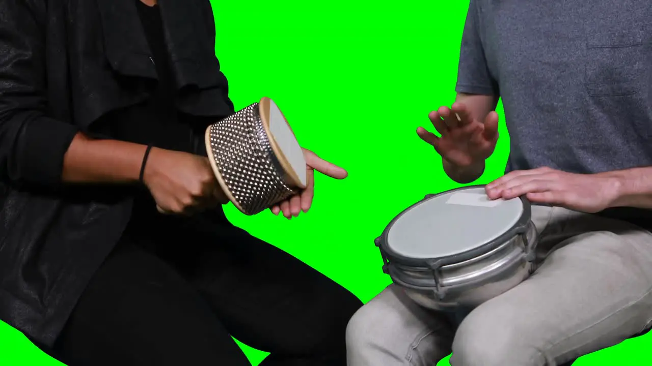 Mid section of musicians playing cabasa and drum