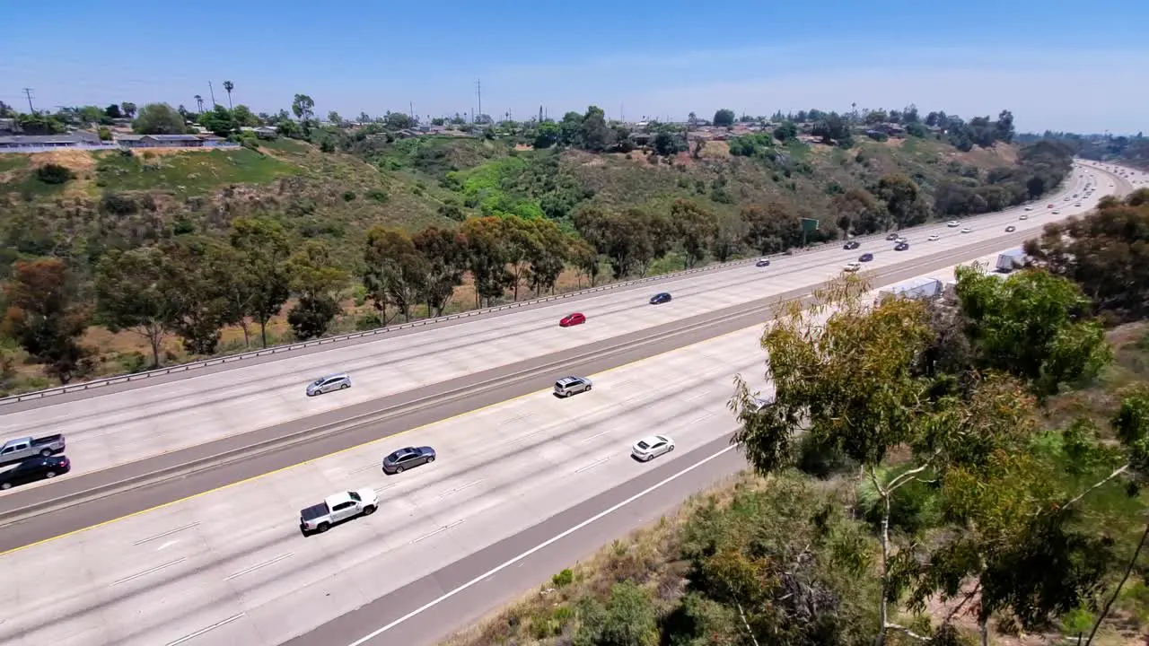 Big rig semi trucks headed southbound on freeway i805 in southern California Locked high angle shot