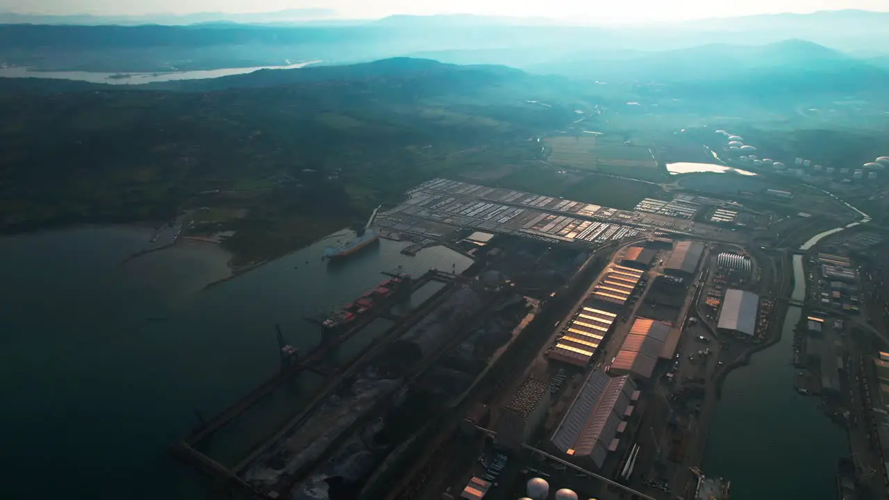 Oil tanks gas silos in harbor docks at sea Koper city Slovenia aerial Fossil fuel transportation over sea by oil tankers green new deal transition to sustainability in trade shipping containers