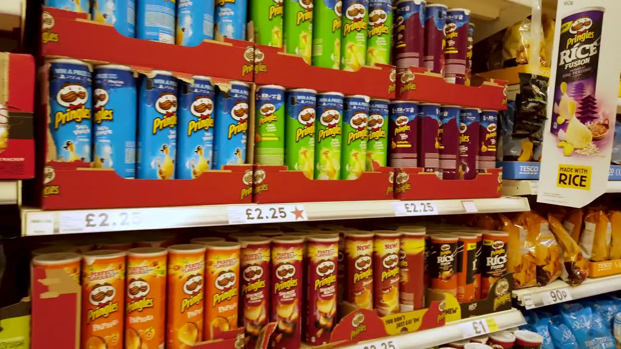 A mass array of processed snack or 'junk' foods on shelf of a British supermarket blamed for obesity of people in Britain