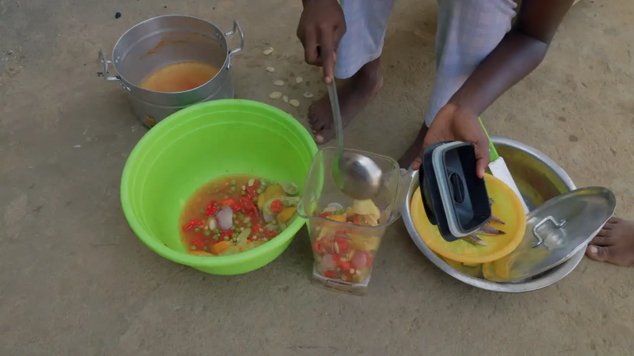 black female chef preparing fufu traditional west African food blending the vegetable